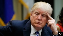 President Donald Trump listens during a meeting at the White House, March 27, 2017.