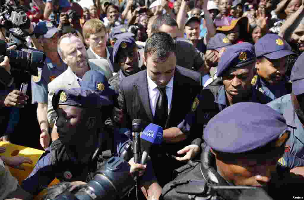 Olympic and Paralympic track star Oscar Pistorius leaves the North Gauteng High Court in Pretoria, Sept, 12, 2014.