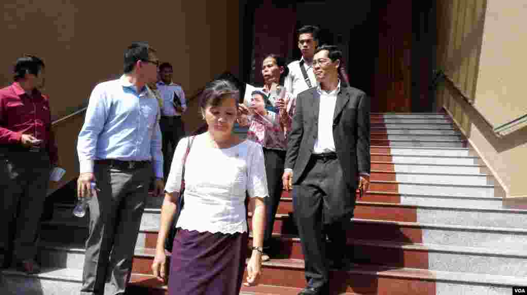 Opposition lawmaker Mu Sochua and her colleagues walk out of the court room after a judge bans them from attending the hearing.