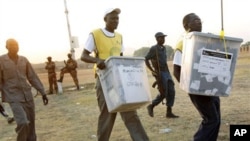 Election officials carry ballot boxes, moments after polls closed in Juba in January 2011. Officials say this year's vote will be held on June 30. 