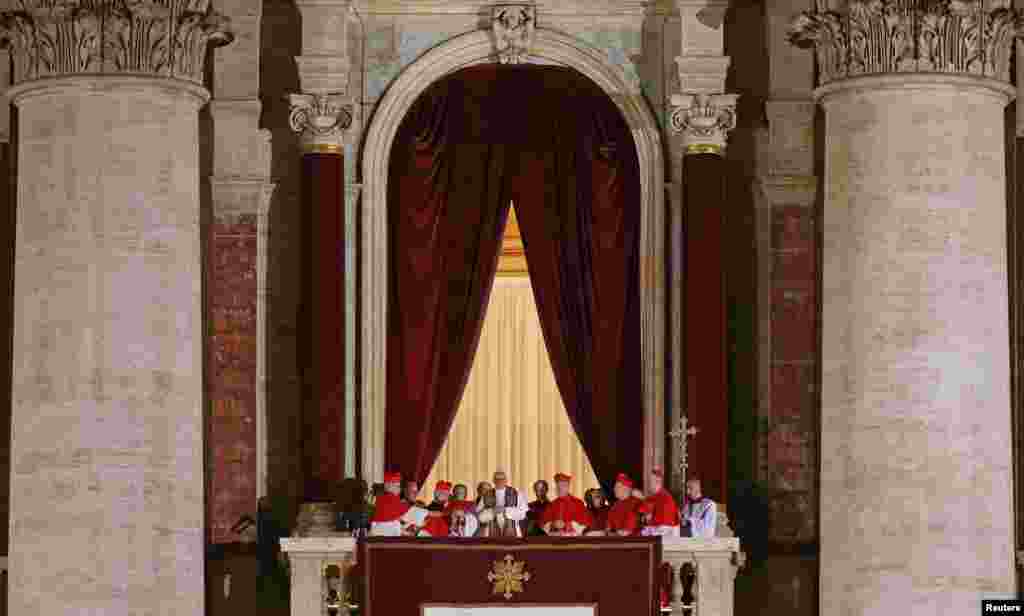 Newly elected Pope Francis, Cardinal Jorge Mario Bergoglio of Argentina appears on the balcony of St. Peter's Basilica after being elected by the conclave of cardinals, at the Vatican, March 13, 2013. White smoke rose from the Sistine Chapel chimney and t