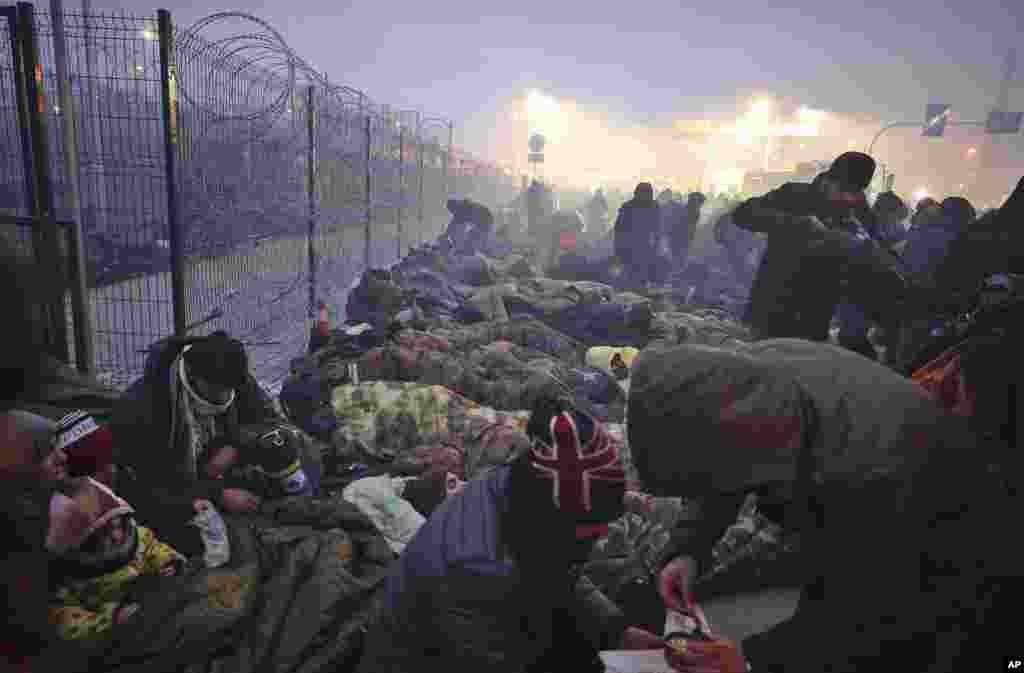 Migrants from the Middle East and elsewhere gather at the checkpoint &quot;Kuznitsa&quot; at the Belarus-Poland border near Grodno, Belarus, Nov. 15, 2021.