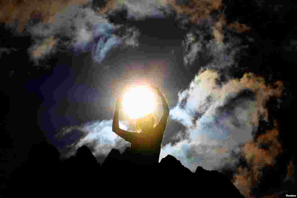 A person celebrates the summer solstice at the Kokino megalithic observatory, near the city of Kumanovo, North Macedonia.