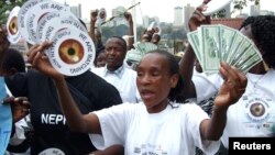 FILE - Kenyan demonstrators take to the streets with calls for increased funding to ensure universal access to HIV/AIDS treatment, in Nairobi.