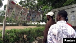 Des Togolais lisent les nouvelles du jour à Lomé, Togo, le 19 mai 2005.