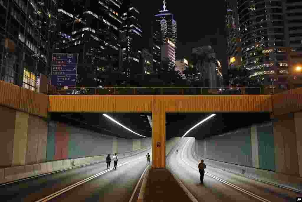 People walk through a tunnel on the main road in the occupied areas in Central, Hong Kong.
