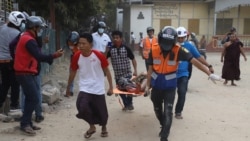 A wounded man is carried on a stretcher by a medical team after security forces opened fire on protesters during a demonstration against the military coup in Mandalay on February 20, 2021. (Photo by str / AFP)