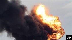 A fuel storage depot, burns after being struck during fighting between rebels and pro-Moammar Gadhafi forces, in Sedra, eastern Libya, March 9, 2011.