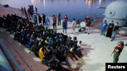 Migrants arrive at a naval base after they were rescued by Libyan Navy, in Tripoli, Libya, Nov. 4, 2017.