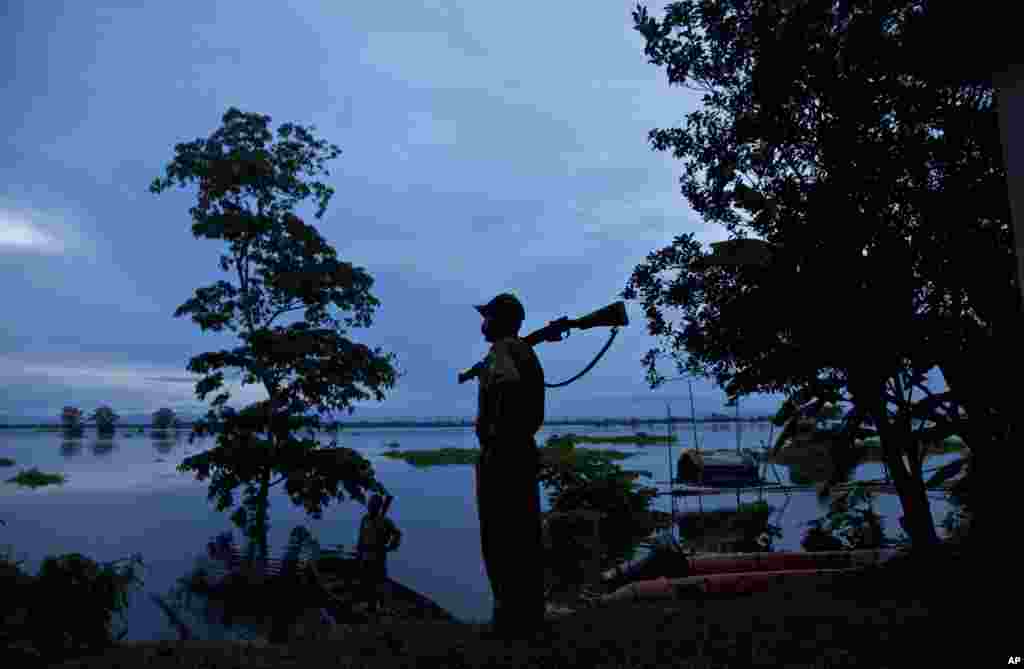 A forest guard keeps vigil at the flooded Kaziranga National Park, east of Gauhati, northeastern Assam state, India.