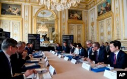 Delegates gather during a "Tech For Good" summit in Paris, May 15, 2019. Several world leaders and tech bosses are meeting in Paris to find ways to stop acts of violent extremism from being shown online.