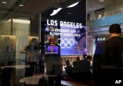 Journalists listen to a presentation at USC's Wallis Annenberg Hall, Los Angeles 2024's proposed site for the main press center, in Los Angeles, May 11, 2017.