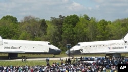 Space shuttles Enterprise (l) and Discovery meet nose-to-nose at the beginning of a transfer ceremony at the Smithsonian's Steven F. Udvar-Hazy Center in Chantilly, Virginia, April 19, 2012.