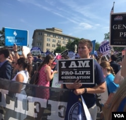 Pro-life demonstrators wave signs and make their voices heard after the Supreme Court upheld abortion rights in a 5-3 decision, in front of the Supreme Court building in Washington, June 27, 2016. (J. Oni / VOA News)