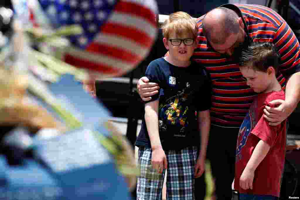 People pay their respects at a makeshift memorial at Dallas Police Headquarters following the multiple police shootings in Dallas, Texas.