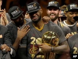 Cleveland Cavaliers forward LeBron James, center, celebrates with teammates after Game 7 of basketball's NBA Finals against the Golden State Warriors in Oakland, Calif., Sunday, June 19, 2016.