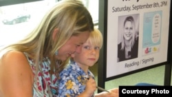 Author Kerry Reichs with her son Declan at a book signing event for "What You Wish For." (Courtesy Photo)