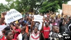 People hold placards reading "Free Rasbath," referring to Mohamed Youssouf Bathily, a young radio presenter also known as "Rasbath," who was arrested, as they take part in a demonstration in front of Bamako's court in Mali, Aug. 17, 2016. Mali blocked social media after the arrest and the violent protests that followed.