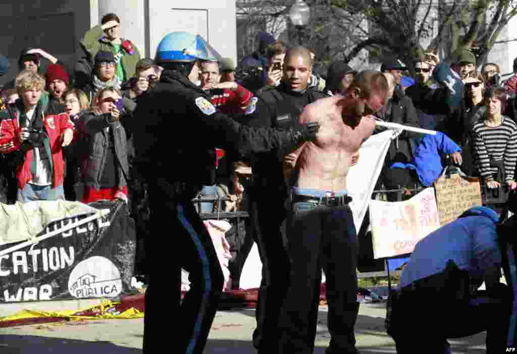 An unidentified protestor is arrested in McPherson Square in downtown Washington Sunday, Dec. 4, 2011. U.S. Park Police are arresting Occupy DC protesters who are refusing to dismantle an unfinished wooden structure erected in the park square overnight. P