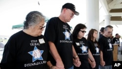 FILE - Protesters hold hands in prayer in Temecula, Calif., at a rally protesting the disenrollment of tribal members, Saturday, May 21, 2005. More than a hundred ousted members of tribes from California and five other states gathered to denounce being di