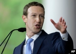 Facebook CEO and Harvard dropout Mark Zuckerberg delivers the commencement address at Harvard University, May 25, 2017, in Cambridge, Mass.