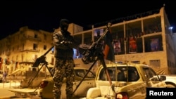FILE - A member of a heavily armed militia group is seen in Benghazi.