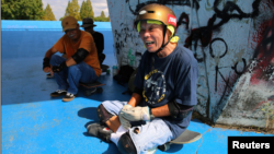 Yoshio Kinoshita takes a break during his skateboarding practice at a park in Daito, Osaka Prefecture, Japan October 6, 2021. (REUTERS/Akira Tomoshige)