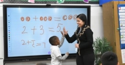Teaching assistant Dilia Samadova teaches a math lesson in Mrs. Zenobi's kindergarten class at Our Lady of Peace School, Dec.11, 2019. (CantonRep.com / Ray Stewart)