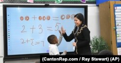 Teaching assistant Dilia Samadova teaches a math lesson in Mrs. Zenobi's kindergarten class at Our Lady of Peace School, Dec.11, 2019. (CantonRep.com / Ray Stewart)
