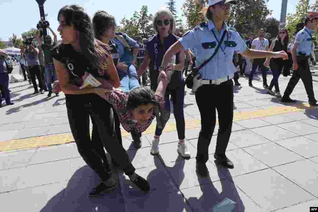 Riot police officers detain protesters during the trial of two Turkish teachers who went on a hunger strike over their dismissal under a government decree following last year's failed coup, outside of a courthouse in Ankara, Turkey.