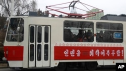 People ride on a tram with red stars stenciled across its side in Pyongyang, North Korea, Feb. 2, 2019. The red stars are awarded for every 50,000 kilometers (31,000 miles) driven without an accident.