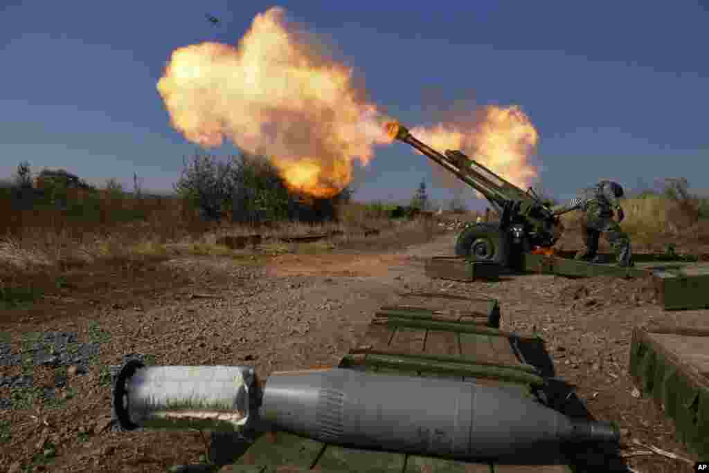 Pro-Russian rebels fire artillery toward Ukrainian position at Donetsk Sergey Prokofiev International Airport on the outskirts the city of Donetsk, eastern Ukraine, Oct. 14, 2014.