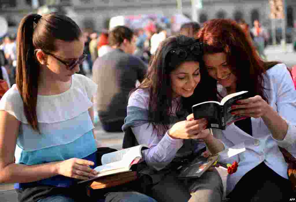 People read free books on International Book Day in Bucharest, Romania.