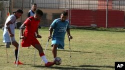 Palestinian amputees play a soccer match while using their crutches during a training session, organized by the International Committee of the Red Cross with the Palestinian Amputee Football Association, at Palestine Stadium in Gaza City, Sunday, Dec. 5,