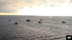 FILE - This handout photo taken from a video released on Apr. 22, 2021 by Russian Defense Ministry Press Service shows, Russian navy ships take part in drills off Crimea in the Black Sea. 