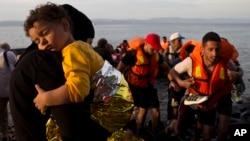 Syrian refugees arrive on a dinghy after crossing from Turkey to Lesbos island, Greece, Sept. 9, 2015. 