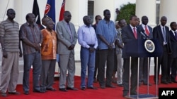 This picture released by the Kenya presidential service shows Kenyan President Uhuru Kenyatta speaking during a press conference with the seven detainees released to his custody by South Sudan President after addressing a press conference at State House in Nairobi, Jan. 29, 2014. 
