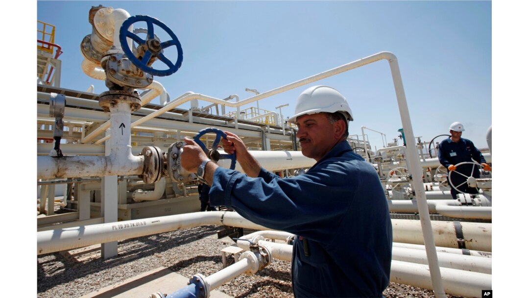 FILE - Employees work at the Tawke oil field in the semiautonomous Kurdish region in northern Iraq, May 31, 2009.