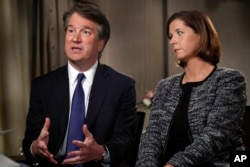 Brett Kavanaugh, with his wife Ashley Estes Kavanaugh, answers questions during a FOX News interview, Sept. 24, 2018, in Washington, about allegations of sexual misconduct against the Supreme Court nominee.