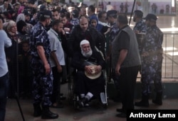 FILE - Palestinians line up for the travel documents check before entering the Rafah border crossing with Egypt, in the southern Gaza Strip, May 11, 2016.