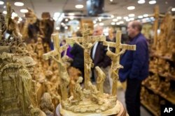 FILE - People visit a shop near the Church of the Nativity, built atop the site where Christians believe Jesus Christ was born, in the West Bank City of Bethlehem, Dec. 6, 2018.