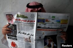 A man reads a newspaper in Riyadh, Saudi Arabia, Nov. 5, 2017.