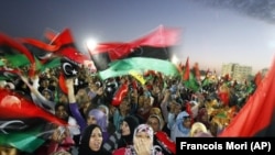  File - In this Sunday Oct. 23, 2011 file photo, Libyan celebrate at Saha Kish Square in Benghazi, Libya.