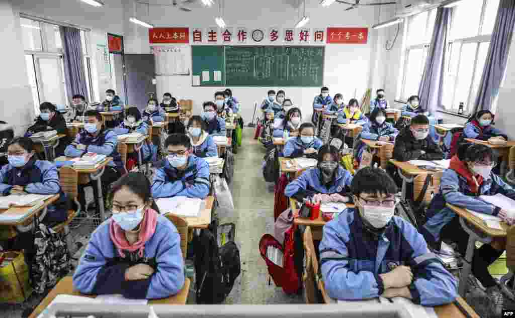 Students return to school after the term opening was delayed due to the COVID-19 coronavirus outbreak, in Huaian in China's eastern Jiangsu province.