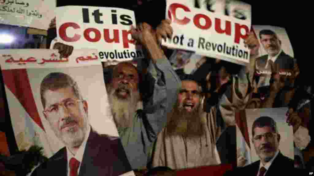 Supporters of Egypt's ousted President Mohamed Morsi pray at Nasr City, where protesters have installed a camp and hold daily rallies, in Cairo, July 28, 2013.