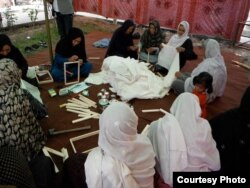 Member of the Memory Box Initiative are preparing frames for the project in Kabul, Afghanistan. (Photo: Afghanistan Human Rights and Democracy Organization)