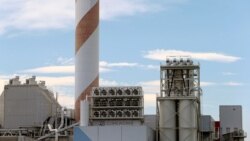 FILE - A facility made by Climeworks AG to capture CO2 from the air is seen on the roof of a waste incinerating plant in Hinwil, Switzerland, July 18, 2017.