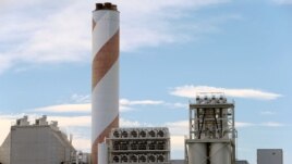 FILE - A facility made by Climeworks AG to capture CO2 from the air is seen on the roof of a waste incinerating plant in Hinwil, Switzerland, July 18, 2017.