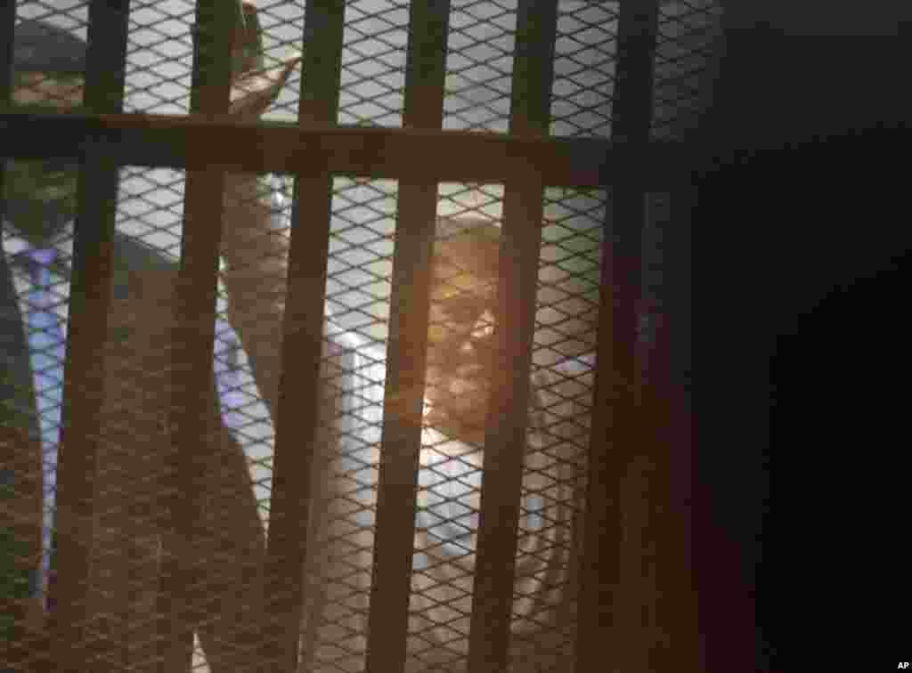 Egypt&#39;s ousted Islamist president Mohamed Morsi sits in a soundproof glass cage inside a makeshift courtroom at Egypt&rsquo;s national police academy in Cairo, April 21, 2015.