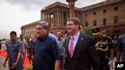 U.S. Defense Secretary Ashton Carter, right, walks with Indian Defense Minister Manohar Parrikar after receiving a ceremonial welcome in New Delhi, India, Wednesday, June 3, 2015
